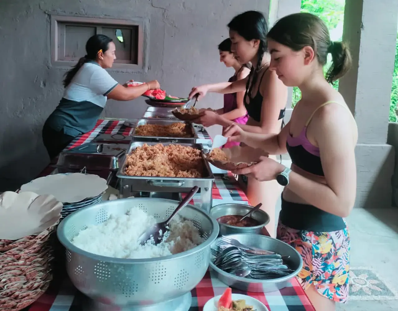 Guests serving themselves rice and Indonesian dishes from the buffet after rafting